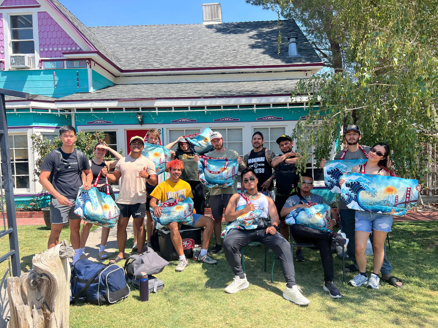 Group of travelers and creatives holding exclusive oversized designer tote bags in front of a house